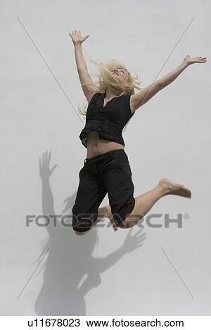 Stock Image - Woman jumping for joy. Fotosearch