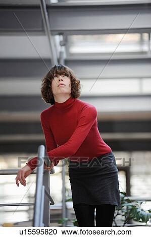 Woman leaning on banister View Large Photo Image Stock Image - Woman leaning on banister. Fotosearch