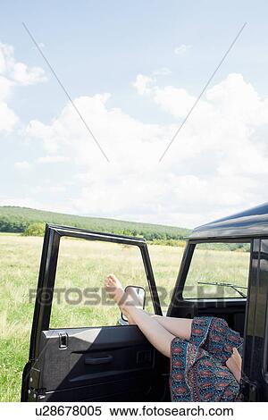 Stock Photography - Woman relaxing in parked car. Fotosearch