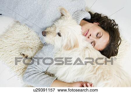 Woman relaxing with dog on rug View Large Photo Image Stock Photo - Woman relaxing with dog on rug. Fotosearch