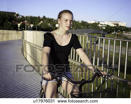 Woman riding bicycle on skybridge View Large Photo Image Stock Image - Woman riding bicycle on skybridge. Fotosearch