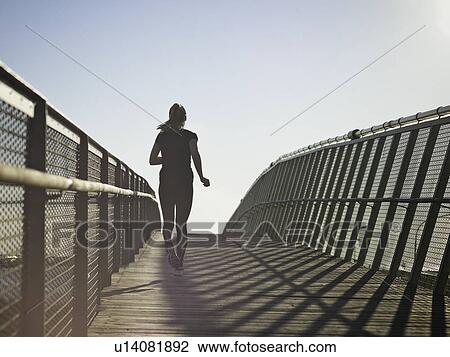 Woman running on skybridge View Large Photo Image Stock Image - Woman running on skybridge. Fotosearch