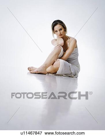 Woman sitting on floor View Large Photo Image Stock Photo - Woman sitting on floor. Fotosearch