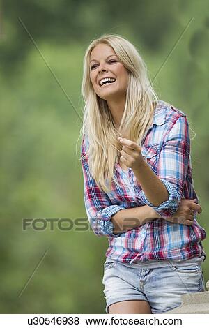 Woman standing in park View Large Photo Image Stock Photo - Woman standing in park. Fotosearch