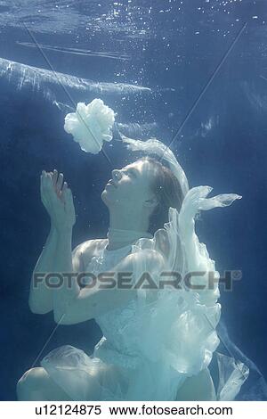 Woman swimming in ornate gown View Large Photo Image Stock Photography - Woman swimming in ornate gown. Fotosearch