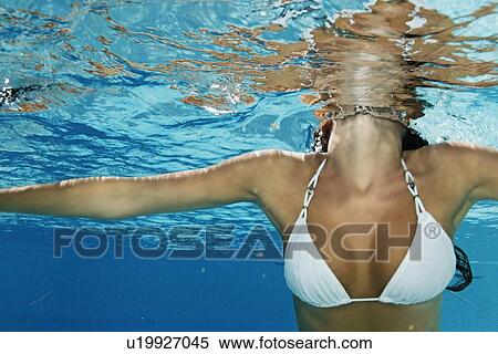 Stock Photography - Woman swimming in pool. Fotosearch