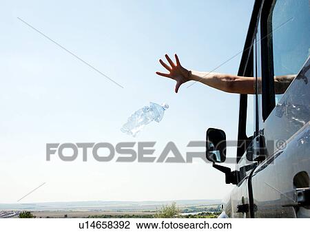 Woman throwing bottle out car window View Large Photo Image Stock Image - Woman throwing bottle out car window. Fotosearch