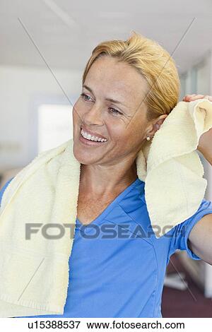 Stock Photo - Woman toweling off in gym. Fotosearch