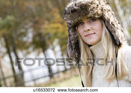 Stock Image - Woman wearing fur hat outdoors. Fotosearch