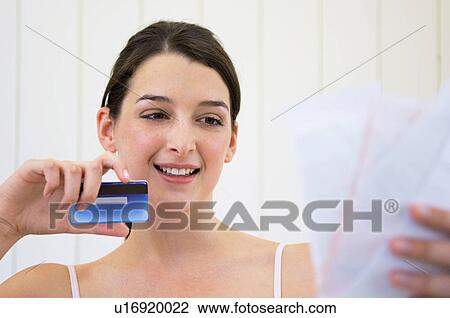Woman with credit card and bills View Large Photo Image Stock Image - Woman with credit card and bills. Fotosearch