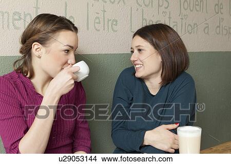 Picture - Women having cup of coffee in cafe. Fotosearch