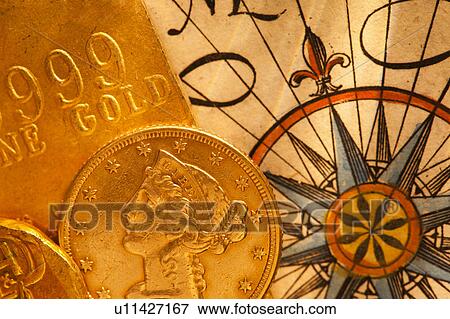 Stock Photo - Antique map and coins, studio shot. Fotosearch