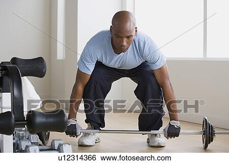 Stock Photograph - Athlete lifting barbell. Fotosearch