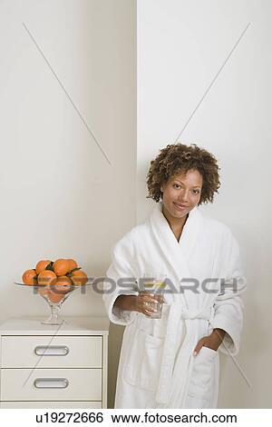 Attractive woman drinking fresh orange juice View Large Photo Image Stock Photograph - Attractive woman drinking fresh orange juice. Fotosearch