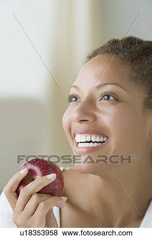 Attractive woman holding apple View Large Photo Image Stock Photo - Attractive woman holding apple. Fotosearch