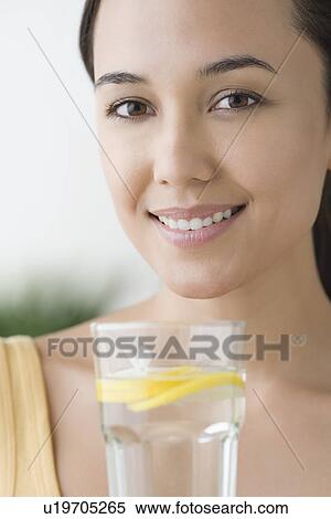 Attractive woman with glass of water View Large Photo Image Stock Photography - Attractive woman with glass of water. Fotosearch