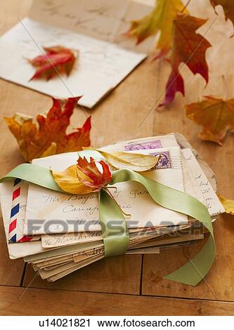 Stock Image - Autumn leaves on letters, studio shot. Fotosearch