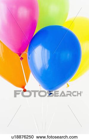 Stock Image - Balloons against white background, studio shot. Fotosearch