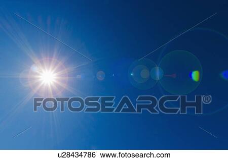 Stock Photograph - Blue sky with solar flare. Fotosearch