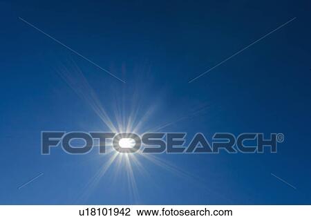 Stock Image - Blue sky with sun. Fotosearch