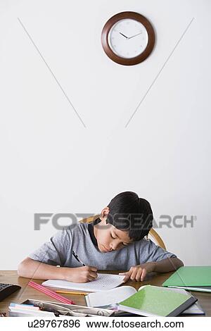 Boy (10-11) doing homework View Large Photo Image Stock Photograph - Boy (10-11) doing homework. Fotosearch