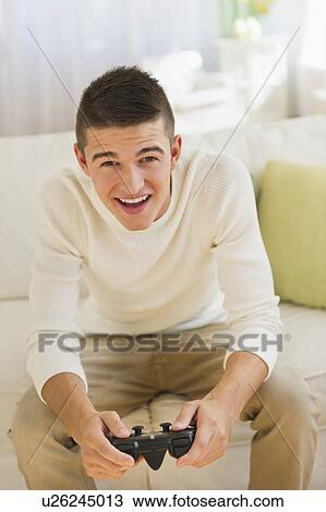Boy (16-17) playing video game View Large Photo Image Stock Image - Boy (16-17) playing video game. Fotosearch