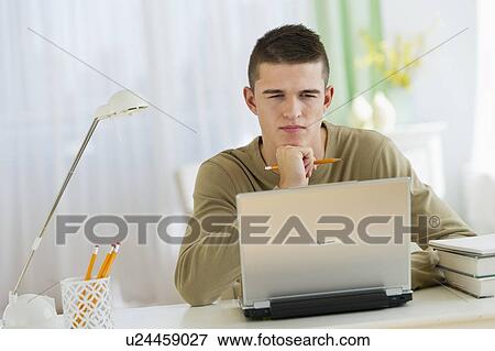 Boy (16-17) using laptop View Large Photo Image Stock Photo - Boy (16-17) using laptop. Fotosearch