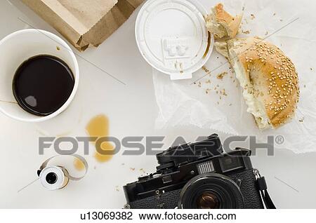 Stock Image - Breakfast and camera on table, studio shot. Fotosearch