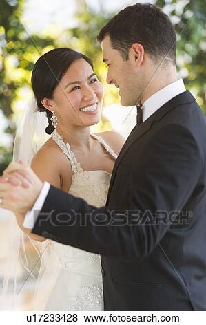 Stock Photo - Bride and groom dancing. Fotosearch