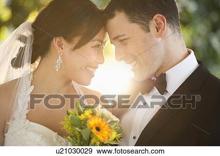 Stock Photo - Bride and groom looking at each other. Fotosearch