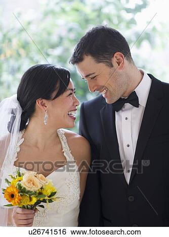 Bride and groom looking at each other View Large Photo Image Stock Photograph - Bride and groom looking at each other. Fotosearch