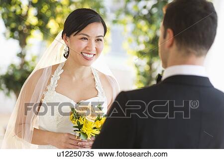 Bride and groom looking at each other View Large Photo Image Stock Photography - Bride and groom looking at each other. Fotosearch