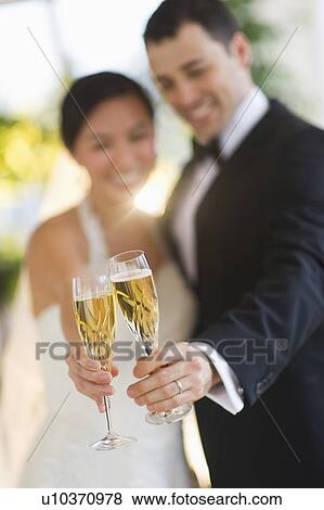 Bride and groom toasting with champagne View Large Photo Image Stock Photo - Bride and groom toasting with champagne. Fotosearch