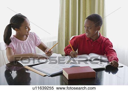 Brother and sister (10-13) doing homework View Large Photo Image Stock Photography - Brother and sister (10-13) doing homework. Fotosearch