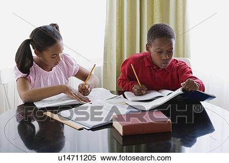 Brother and sister (10-13) doing homework View Large Photo Image Stock Photography - Brother and sister (10-13) doing homework. Fotosearch