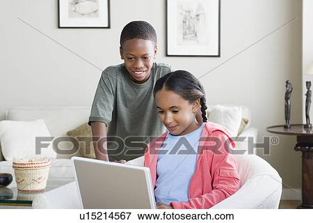 Brother and sister (10-13) using laptop View Large Photo Image Stock Photo - Brother and sister (10-13) using laptop. Fotosearch