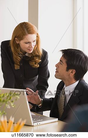 Stock Image - Business man and woman talking. Fotosearch