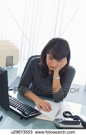 Business woman reading documents View Large Photo Image Stock Image - Business woman reading documents. Fotosearch