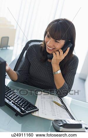 Stock Image - Business woman talking on phone. Fotosearch