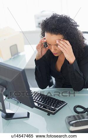 Business woman using computer holding head in hands View Large Photo Image Stock Photography - Business woman using computer holding head in hands. Fotosearch
