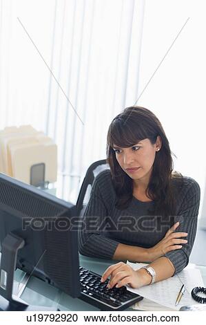 Business woman using computer, looking tired View Large Photo Image Stock Image - Business woman using computer, looking tired. Fotosearch
