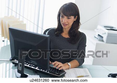 Business woman using computer View Large Photo Image Stock Image - Business woman using computer. Fotosearch