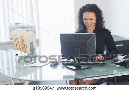 Business woman using computer View Large Photo Image Stock Photo - Business woman using computer. Fotosearch
