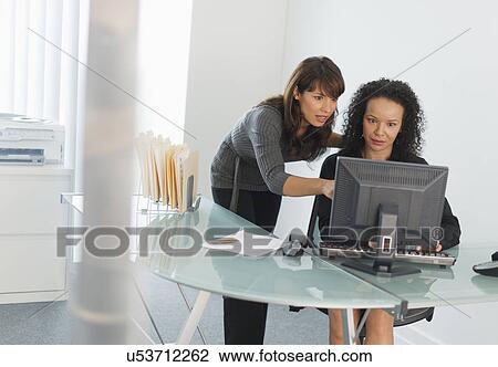 Business women looking at computer View Large Photo Image Stock Image - Business women looking at computer. Fotosearch