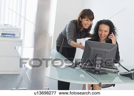Business women looking at computer View Large Photo Image Stock Photo - Business women looking at computer. Fotosearch