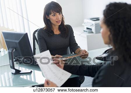 Business women talking in office View Large Photo Image Stock Photo - Business women talking in office. Fotosearch