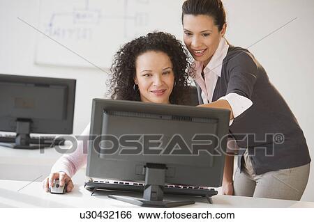 Business women using computer in office View Large Photo Image Stock Photograph - Business women using computer in office. Fotosearch