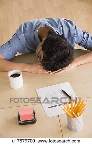 Businessman resting head on desk View Large Photo Image Stock Image - Businessman resting head on desk. Fotosearch