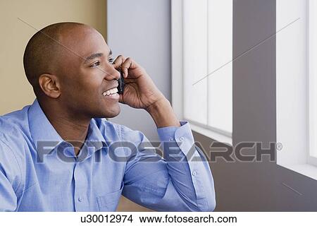 Businessman talking on mobile View Large Photo Image Picture - Businessman talking on mobile. Fotosearch
