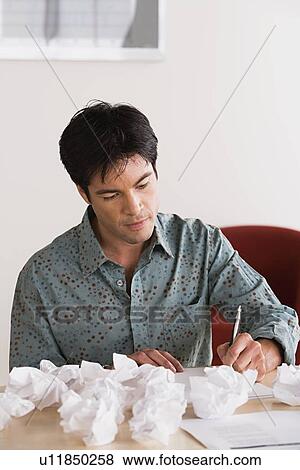 Stock Photo - Businessman with crumpled paper balls. Fotosearch